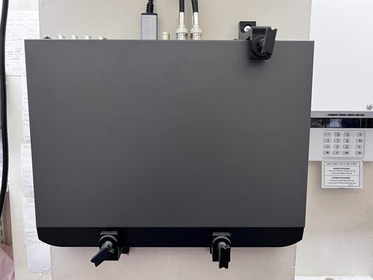 CCTV recorder mounted upright on a wall with three adjustable brackets, two under the bottom edge and one over the top