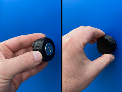 Hand holding the Original magnetic AirTag holder, showing the magnet face and the ribbed lid