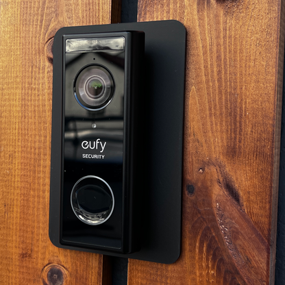 Eufy doorbell on the black wall plate fitted to a wooden door frame