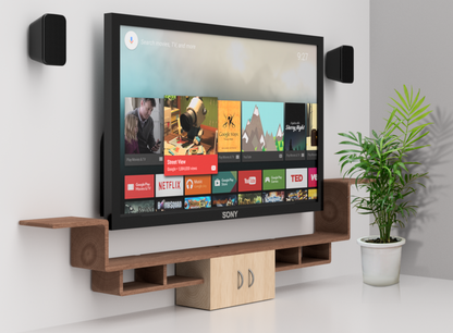 Surround speakers wall mounted either side of a TV in a living room