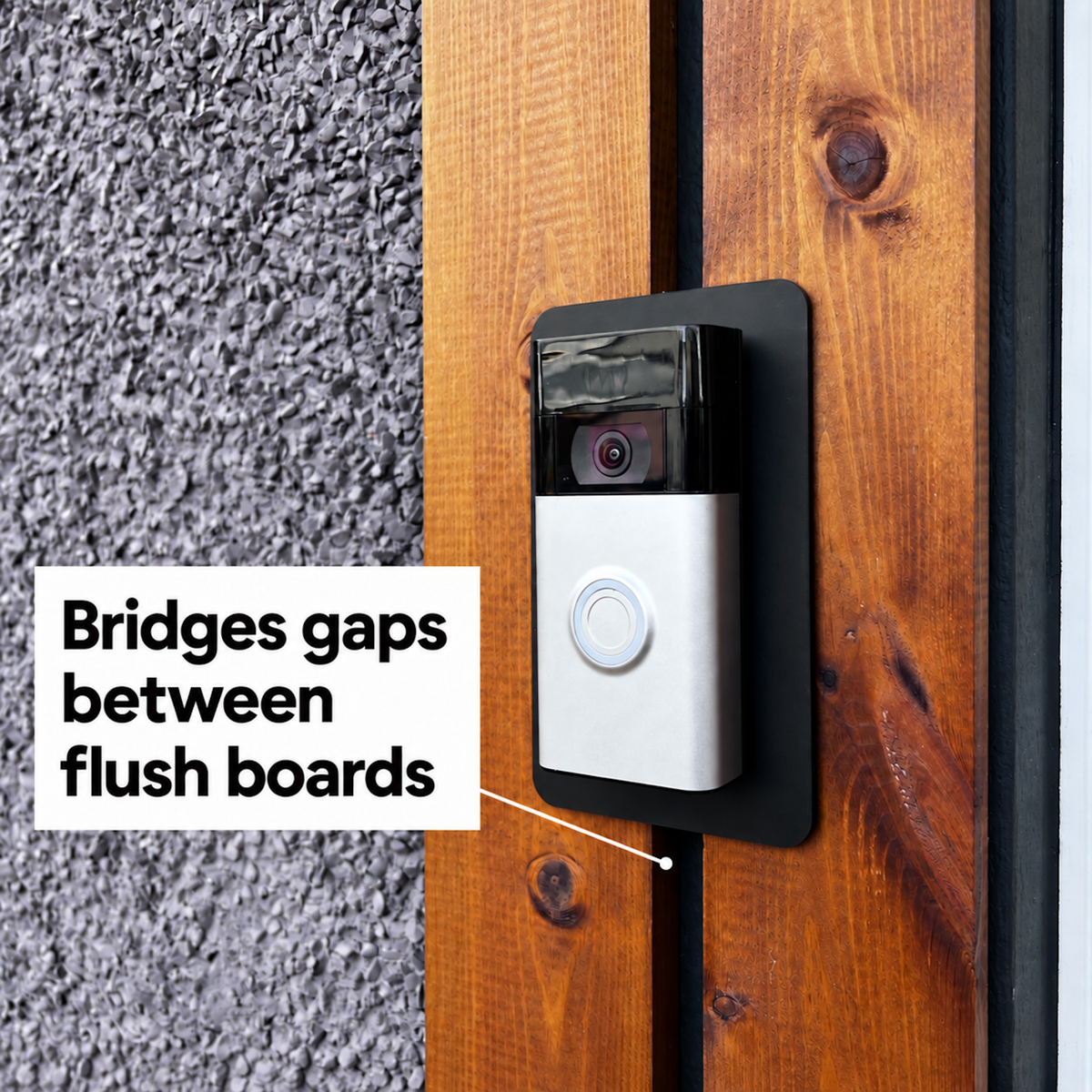 Black wall plate bridging the gap between two flush timber boards behind a video doorbell